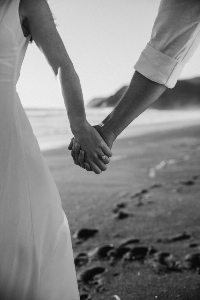 Couple holding hands on the beach