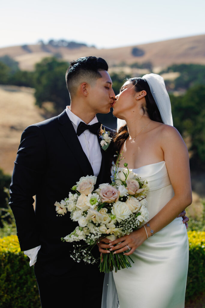 Bride and groom sharing a kiss.