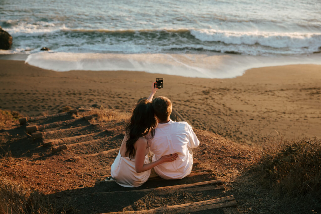 Couple taking a photo together at black sands beach