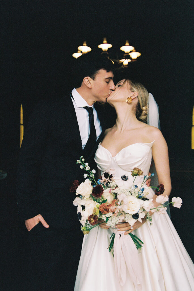 Bride and groom kissing at old St. Hilary's Chapel, Tiburon. 