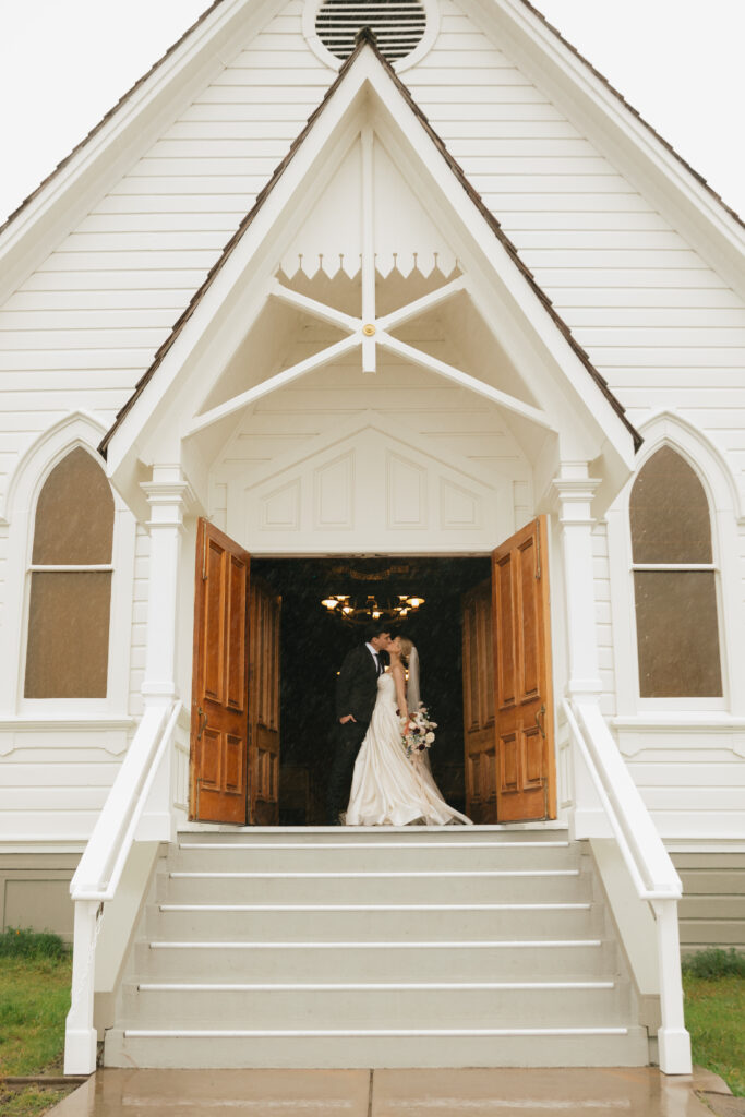 Bride and groom kissing at old St. Hilary's Chapel, Tiburon. 