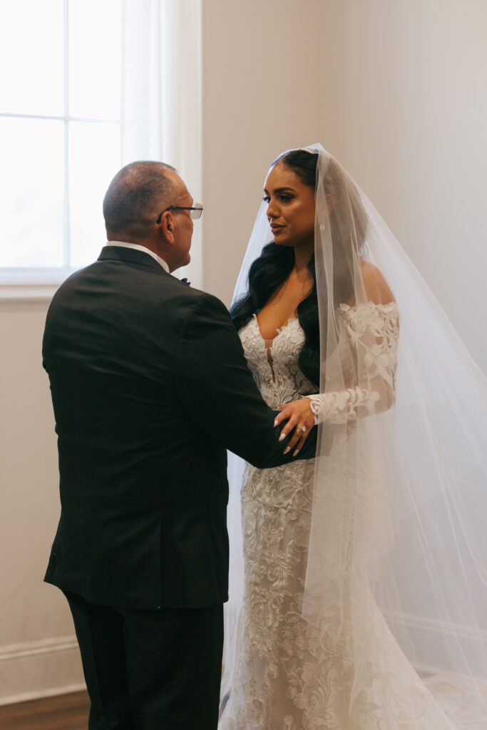 bride doing first look with father. 