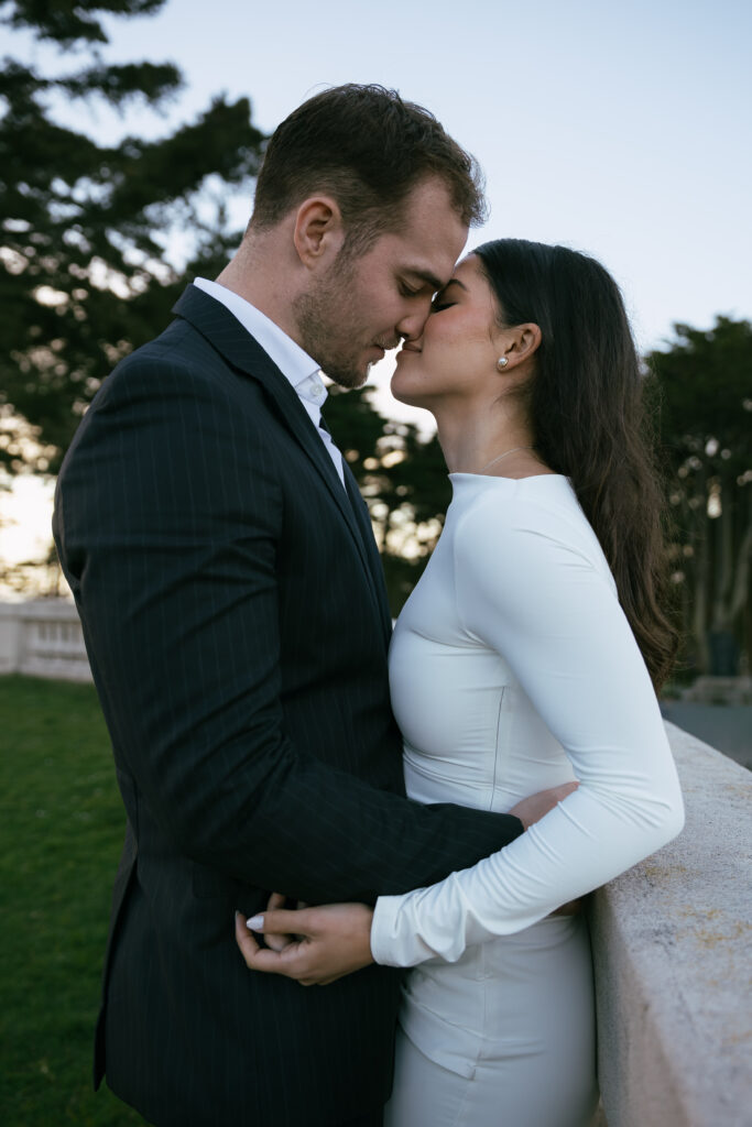 Romantic portrait by an engagement photographer San Francisco at the Legion of Honor with soft coastal light and classic columns in the background.