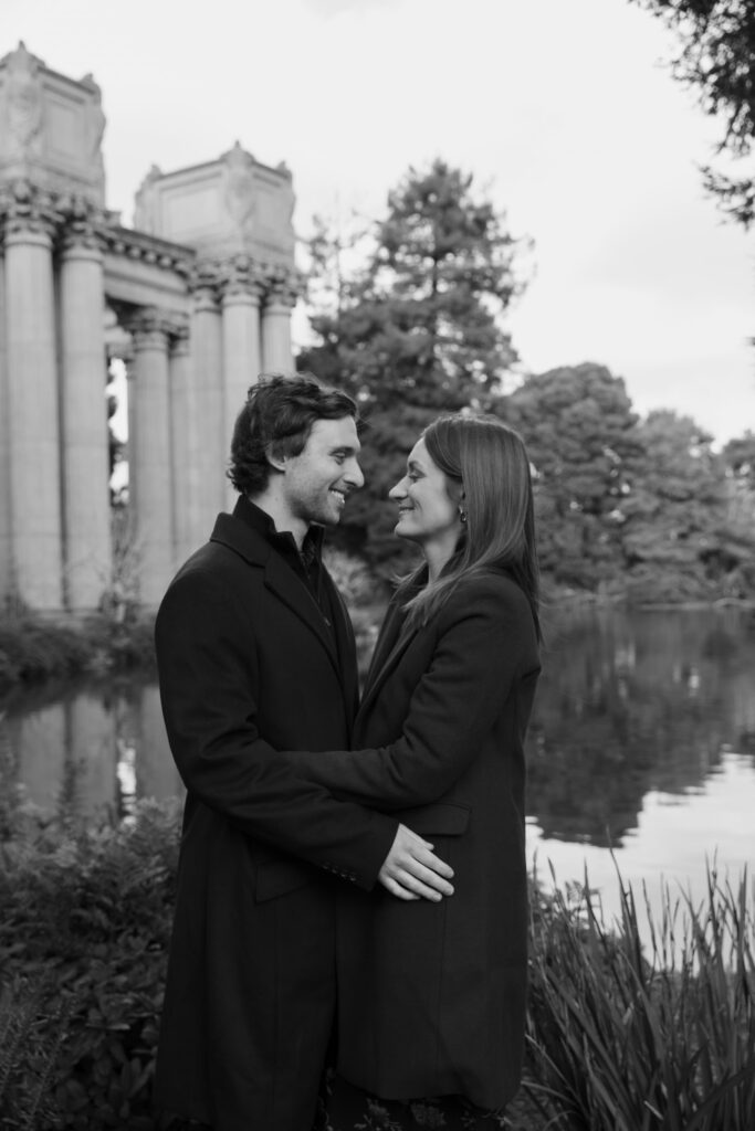 Couple at Palace of Fine Arts pond, black and white engagement photography San Francisco