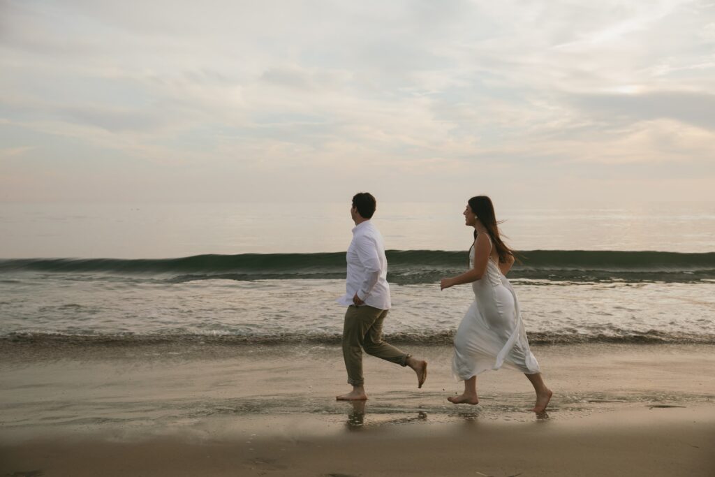 Couple running on the beach at Point Reyes, Bay Area engagement photographer Rose Freedman