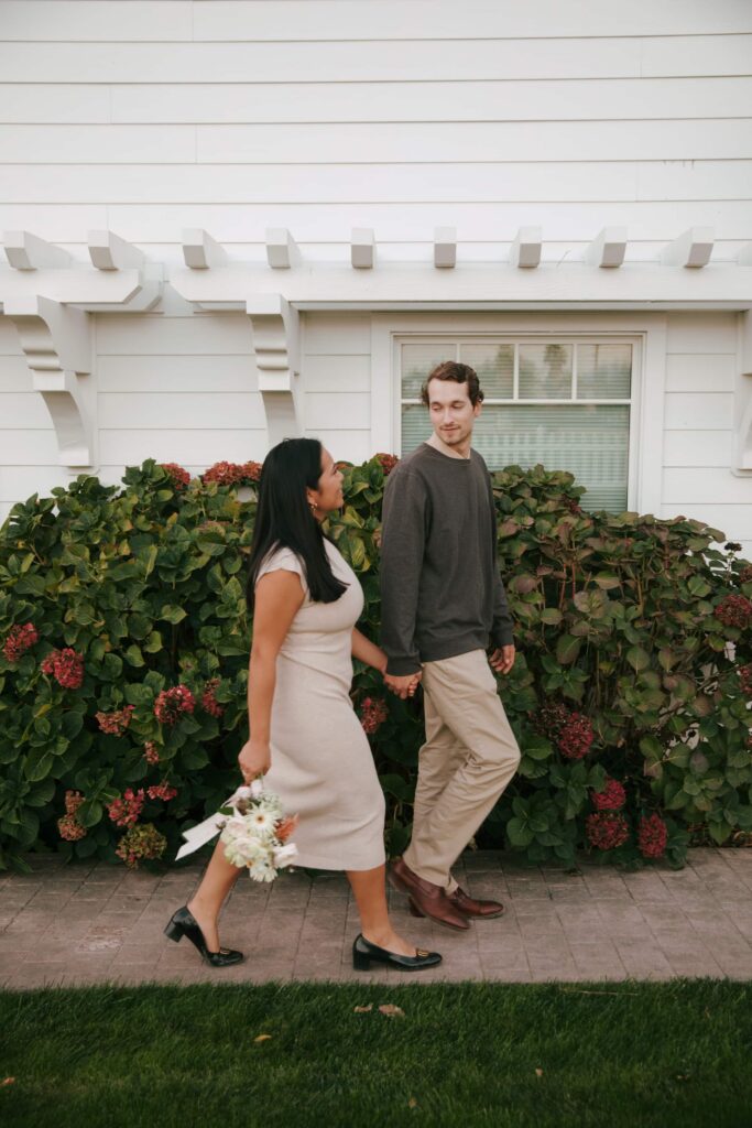 Couple walking hand in hand outside charming Napa farmhouse, Bay Area engagement session