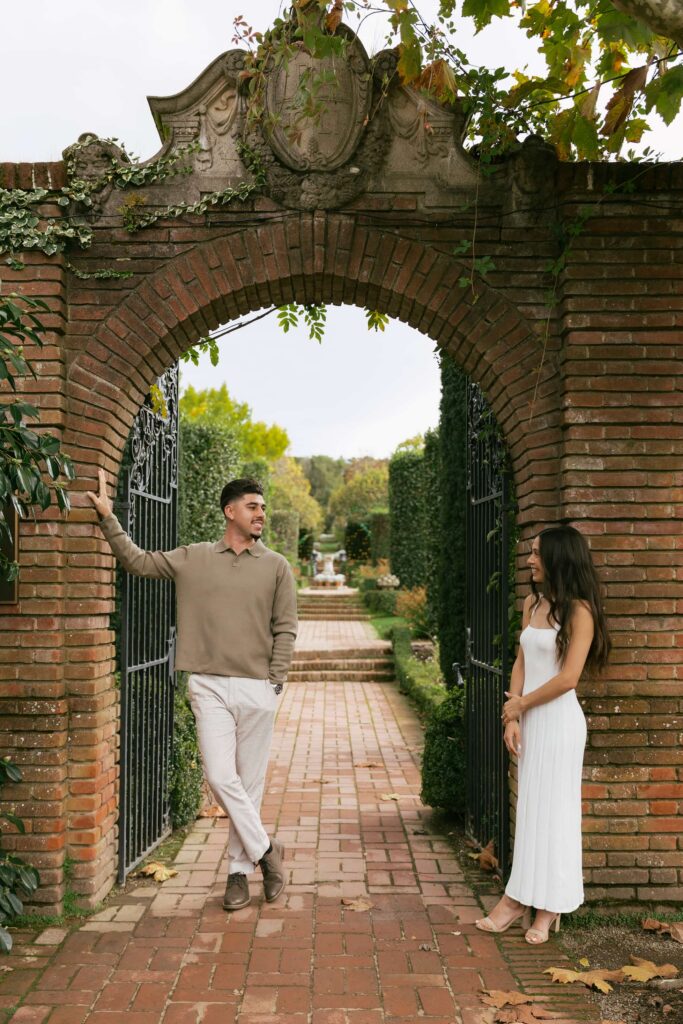 Couple laughing at Filoli Estate garden gate, Bay Area engagement photographer Rose Freedman