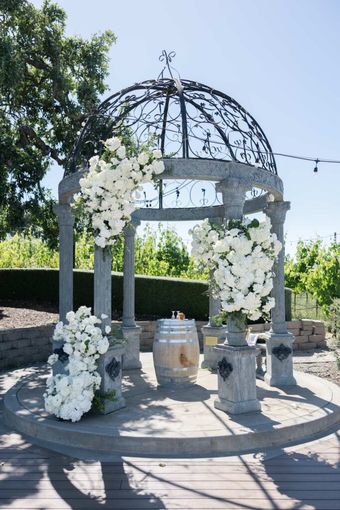 White floral ceremony arch at Meritage Resort and Spa Napa Valley wedding