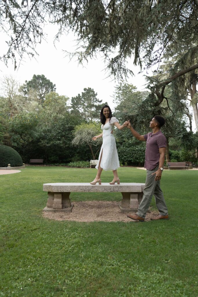 Couple dancing and laughing at Shakespeare Garden Golden Gate Park, San Francisco engagement photographer Rose Freedman
