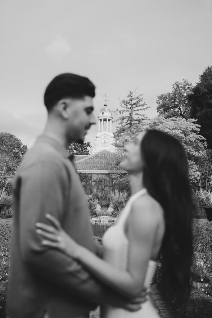Couple in soft focus with Filoli Estate house in background, Bay Area engagement photographer Rose Freedman