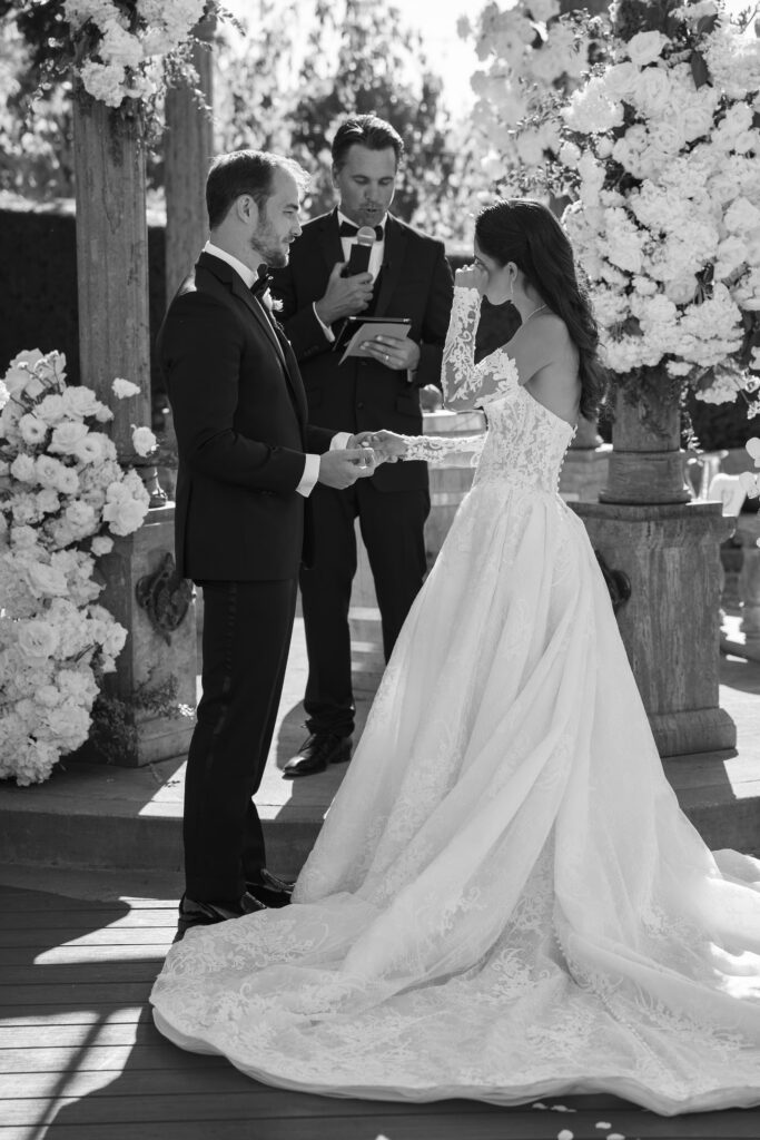 Bride and groom exchanging vows at Meritage Resort Napa, black and white wedding ceremony photo