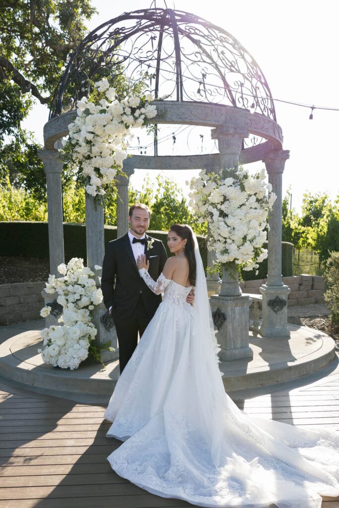 Bride and groom portrait under floral gazebo at Meritage Resort Napa Valley wedding