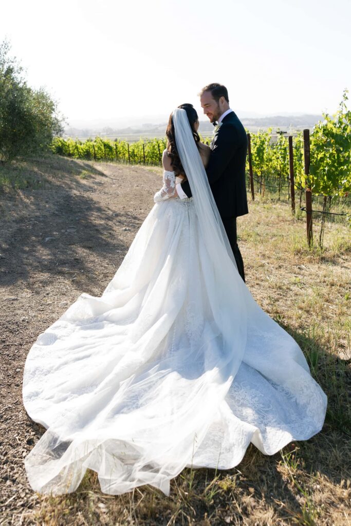 Bride and groom portrait in Napa Valley vineyard at Meritage Resort, bride in lace gown with cathedral veilBride and groom portrait in Napa Valley vineyard at Meritage Resort, bride in lace gown with cathedral veil