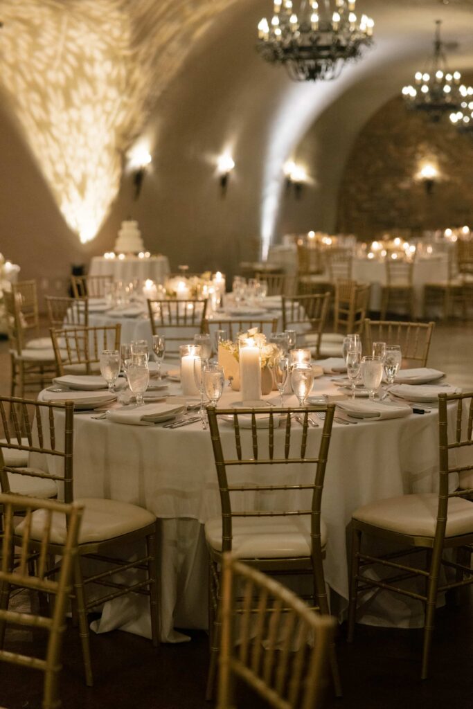 Candlelit cave wedding reception at Meritage Resort Napa with gold chiavari chairs and white floral centerpieces