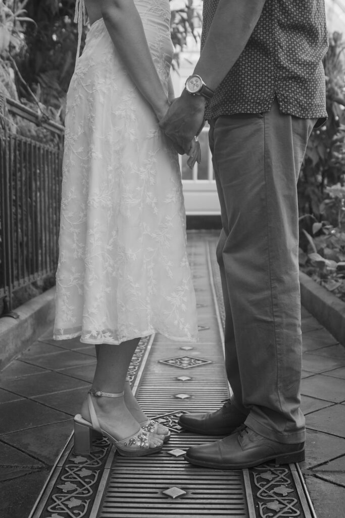 Couple holding hands detail at Conservatory of Flowers, San Francisco engagement photographer Rose Freedman