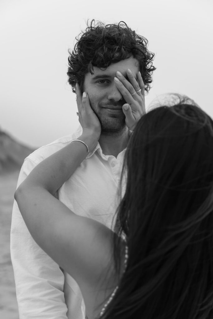 Playful engagement portrait at Half Moon Bay, black and white couples photography Bay Area
