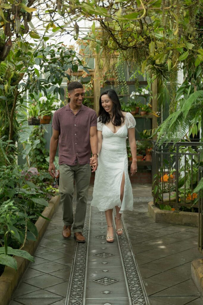 Couple walking through Conservatory of Flowers Golden Gate Park, Bay Area engagement photographer Rose Freedman