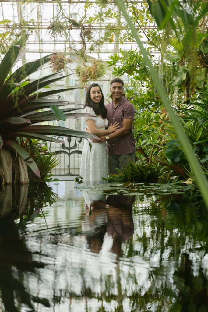Couple reflected in lily pond at Conservatory of Flowers San Francisco, Bay Area engagement photographer Rose Freedman