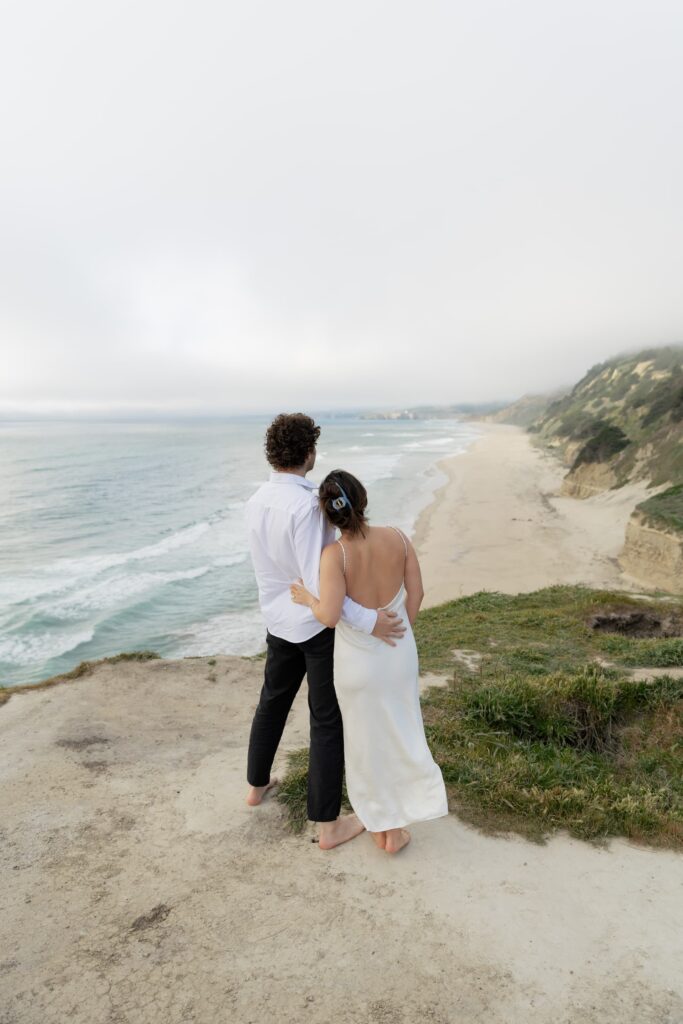 Couple overlooking Half Moon Bay coastline, Bay Area engagement photographer Rose Freedman