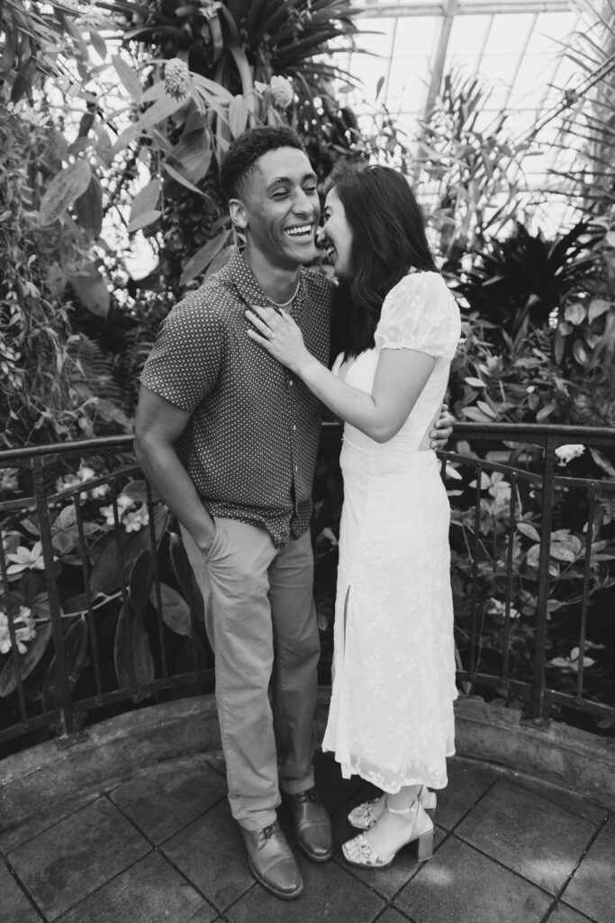 Couple laughing together at Conservatory of Flowers Golden Gate Park, Bay Area engagement photographer Rose Freedman
