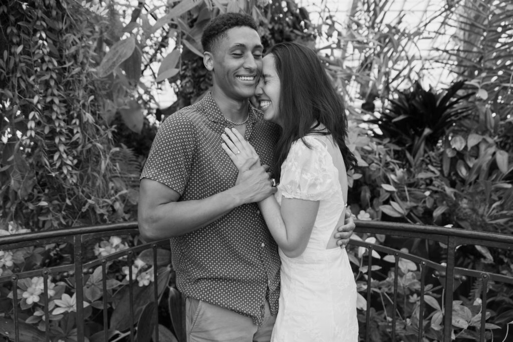 Couple laughing together inside Conservatory of Flowers Golden Gate Park, San Francisco engagement photographer Rose Freedman