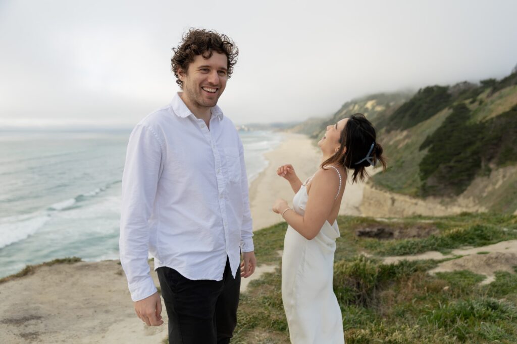 Claude responded: Laughing couple on Half Moon Bay coastal bluffs, Bay Area engagement photographer Rose FreedmanLaughing couple on Half Moon Bay coastal bluffs, Bay Area engagement photographer Rose Freedman