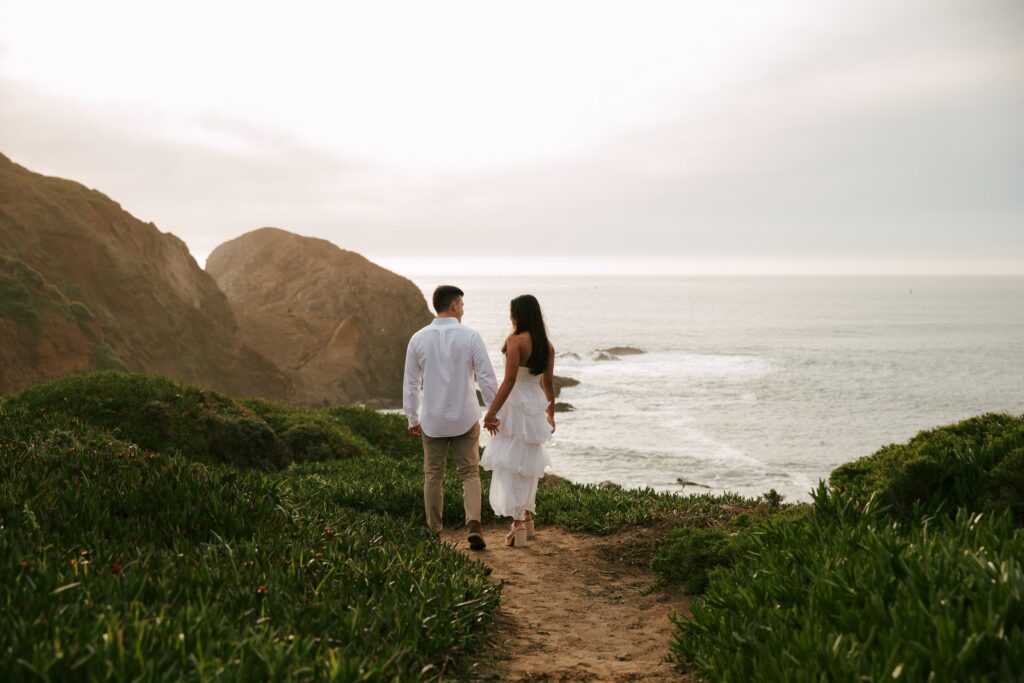 Couple walking toward ocean at Rodeo Beach Marin Headlands engagement session, Bay Area engagement photographer Rose Freedman
