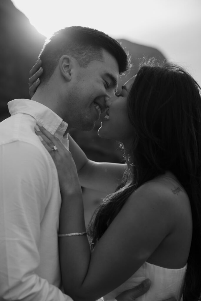Black and white intimate couple portrait at Rodeo Beach, Bay Area engagement photographer Rose Freedman
