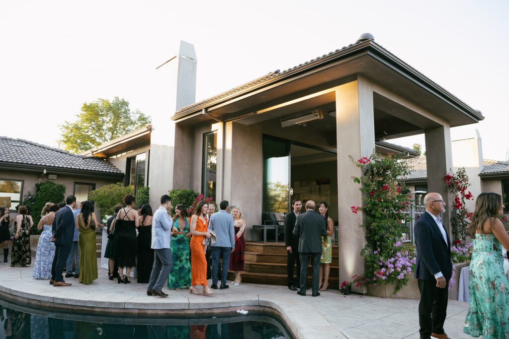 Guests celebrating at Los Gatos private estate engagement party by pool, Bay Area engagement party photographer Rose Freedman