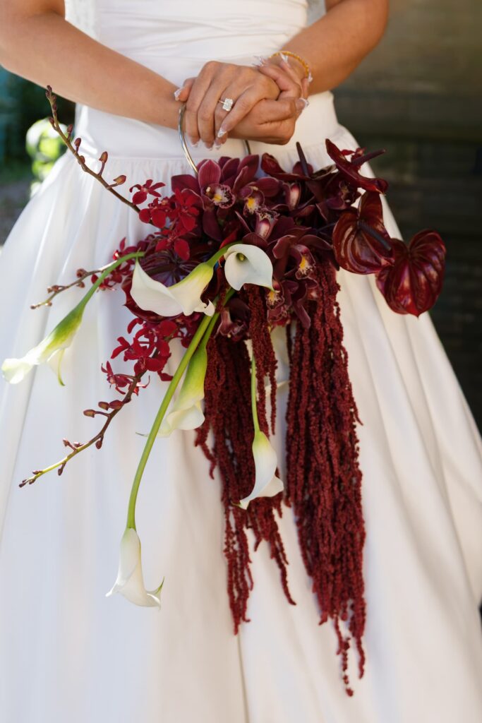 Bride holding burgundy orchid and calla lily cascading bouquet at Palace of Fine Arts wedding, San Francisco wedding photographer Rose Freedman