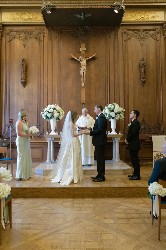 Wedding ceremony at Catholic chapel with bride and groom at altar, San Francisco wedding photographer Rose Freedman