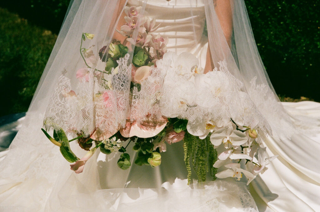 Cascading bridal bouquet with white orchids and lace veil detail on 35mm film, Park Winters wedding photographer Rose Freedman