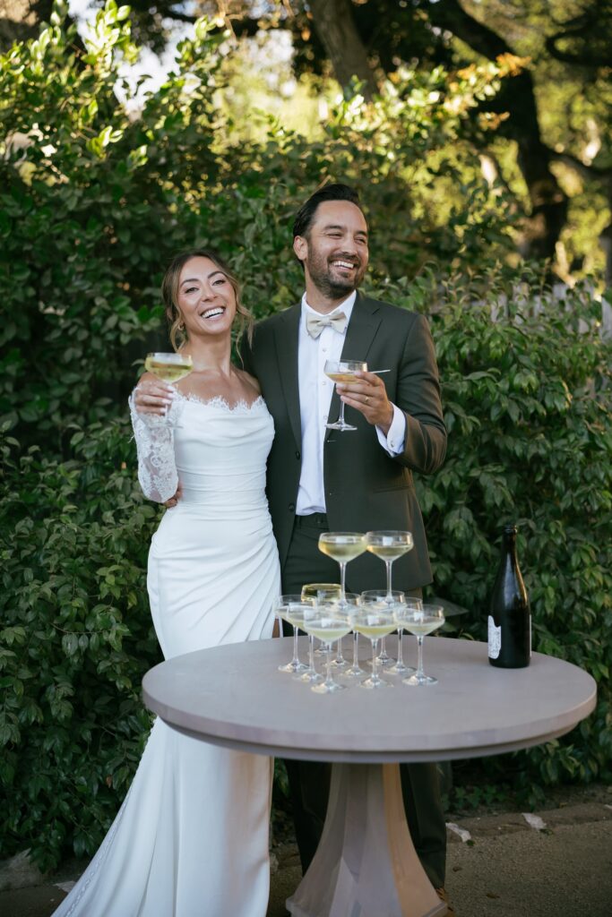 Bride and groom toasting with champagne at Holman Ranch wedding, Carmel Valley wedding photographer Rose Freedman