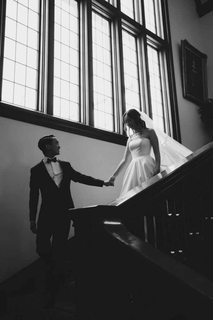 Bride and groom on ornate staircase at Kohl Mansion Burlingame, Peninsula wedding photographer Rose Freedman