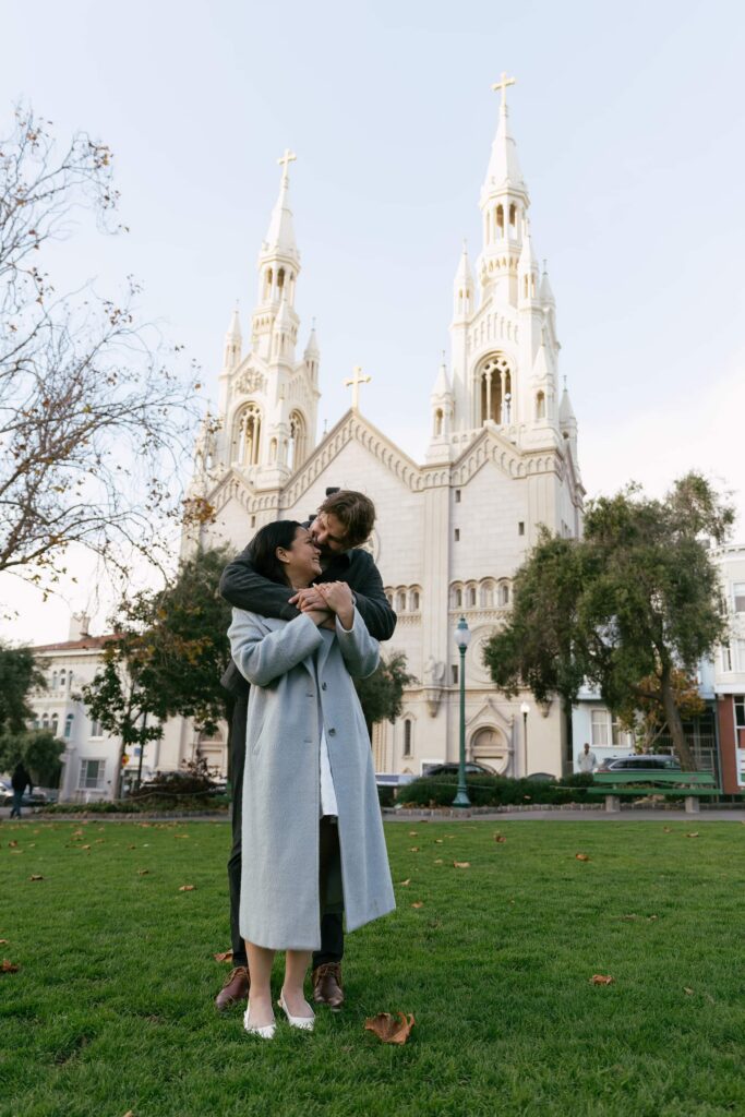 Couple laughing at Saints Peter and Paul Church Washington Square Park San Francisco, Bay Area engagement photographer
