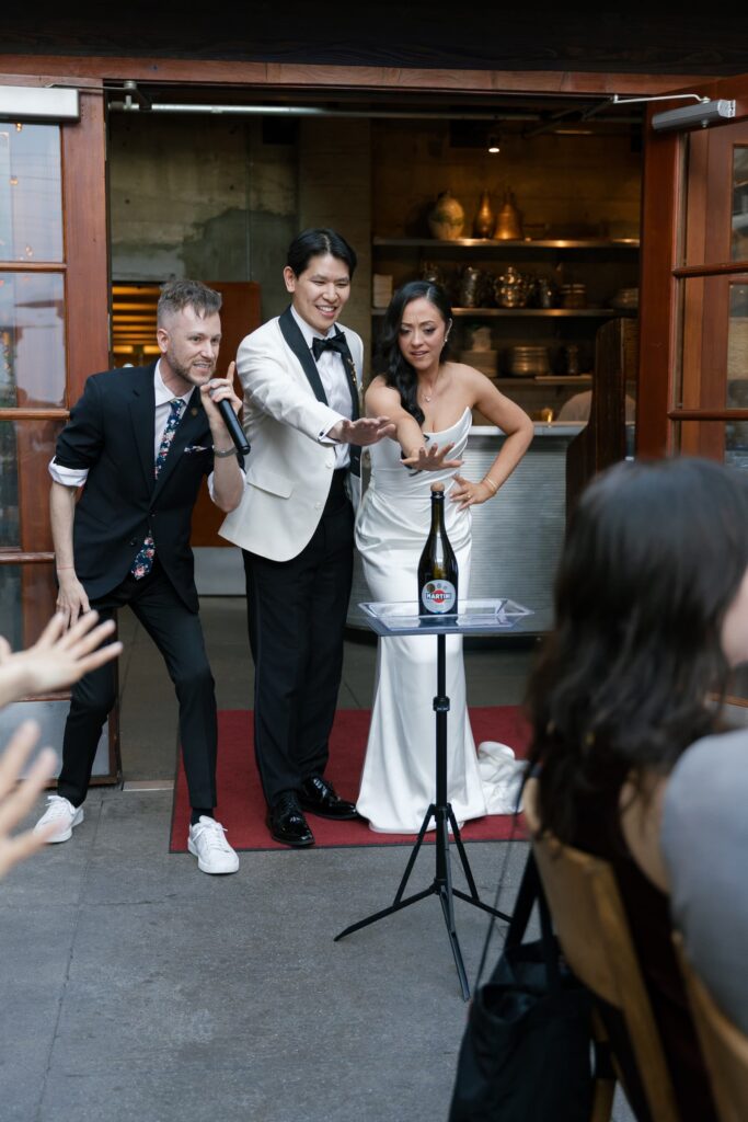 Bride and groom with wedding magician at Foreign Cinema San Francisco reception, San Francisco wedding photographer Rose Freedman
