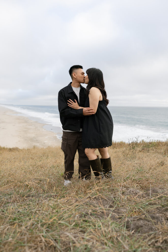 Couple kissing on Half Moon Bay coastal bluff, Bay Area couples photographer Rose Freedman