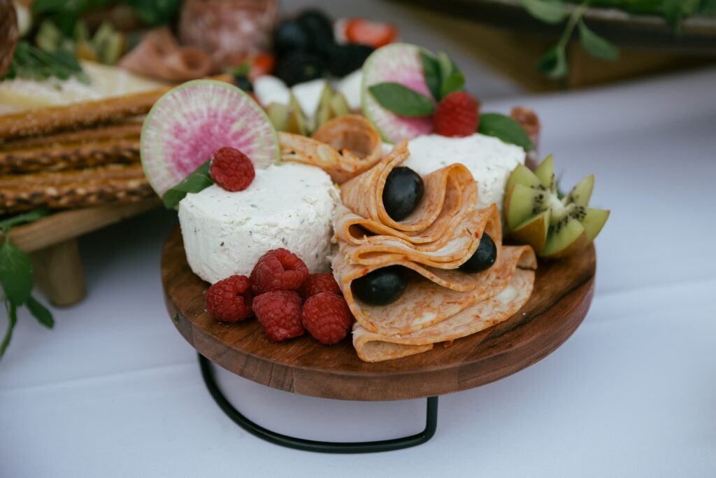Charcuterie board with cheese and raspberries at Los Gatos private estate engagement party, Rose Freedman Photography