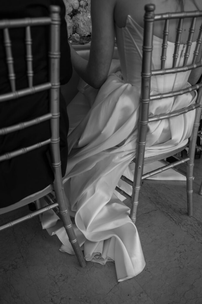 Bride's wedding gown pooling on floor beside chiavari chair, San Francisco wedding photographer Rose Freedman