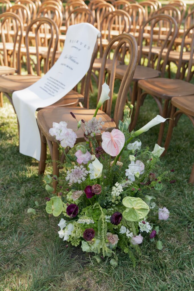 Reserved ceremony seat drape in memory of groom's father with aisle floral arrangement at Park Winters wedding, Rose Freedman Photography