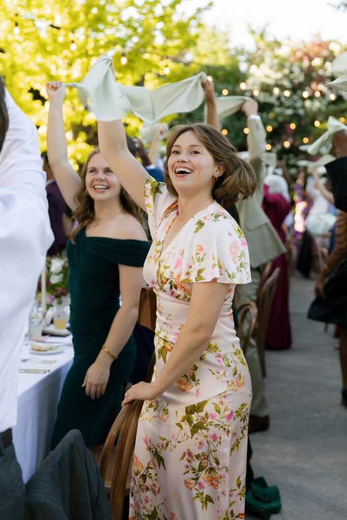 Wedding guests waving napkins and celebrating at Park Winters outdoor reception, Rose Freedman Photography
