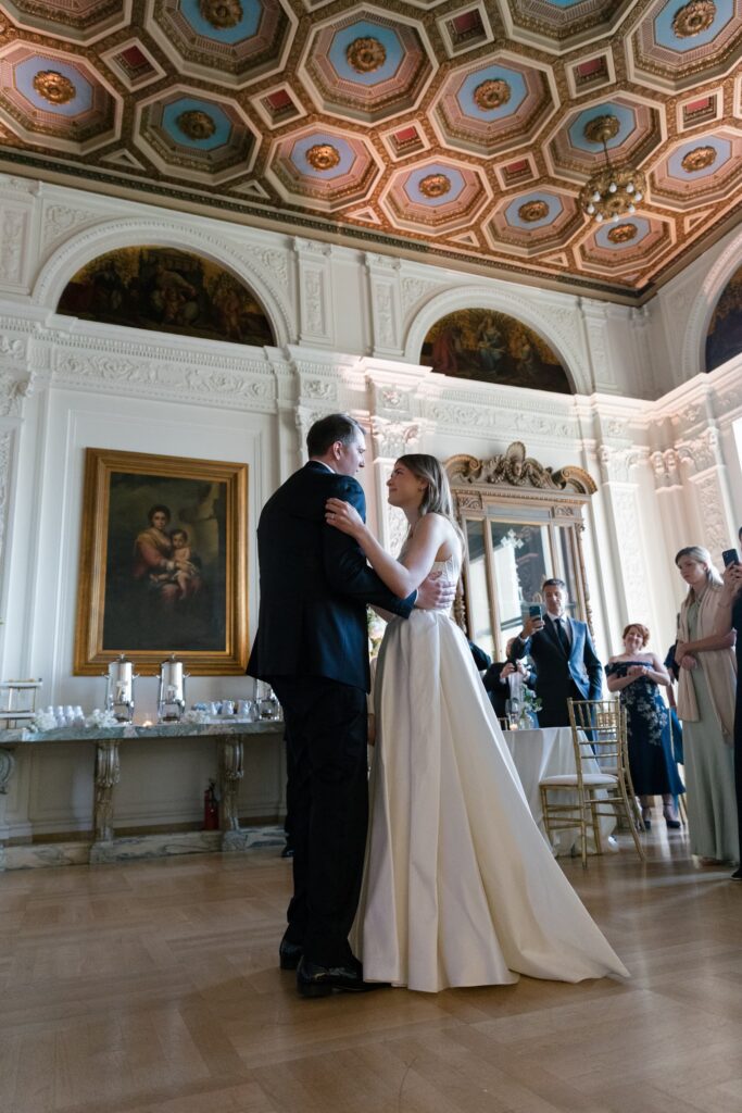 Bride and groom first dance in Flood Mansion grand ballroom with ornate painted ceiling, San Francisco wedding photographer Rose Freedman