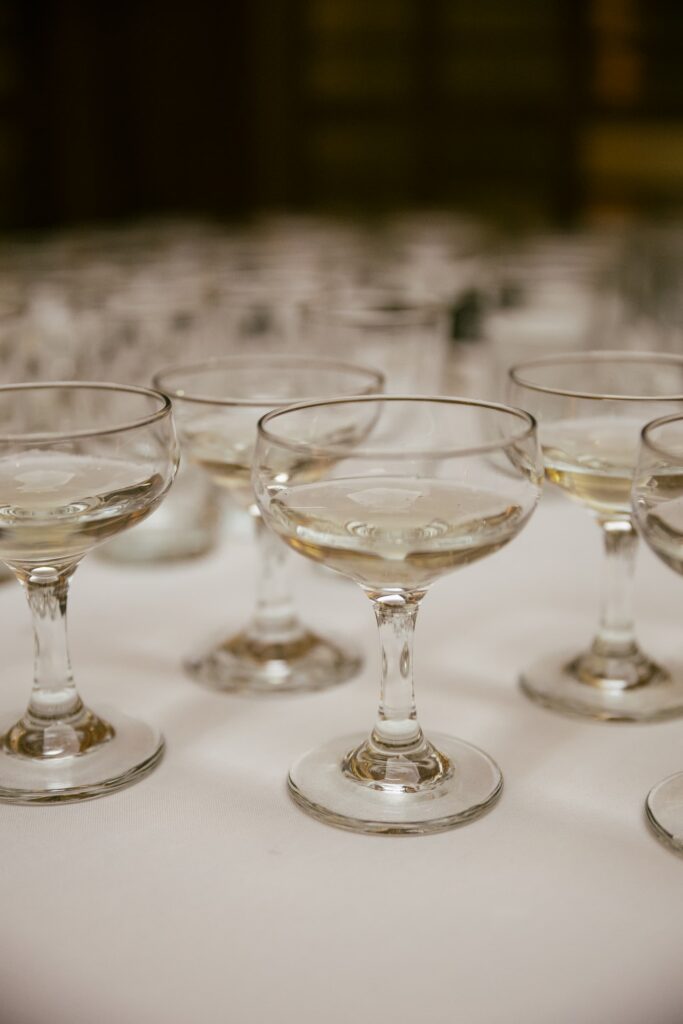 Champagne coupe glasses at Kohl Mansion wedding cocktail hour, Bay Area wedding photographer Rose Freedman