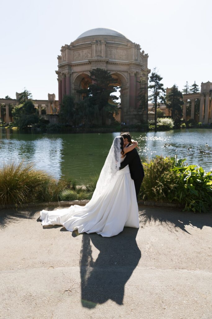 Bride and groom kissing at Palace of Fine Arts lagoon San Francisco wedding, San Francisco wedding photographer Rose Freedman