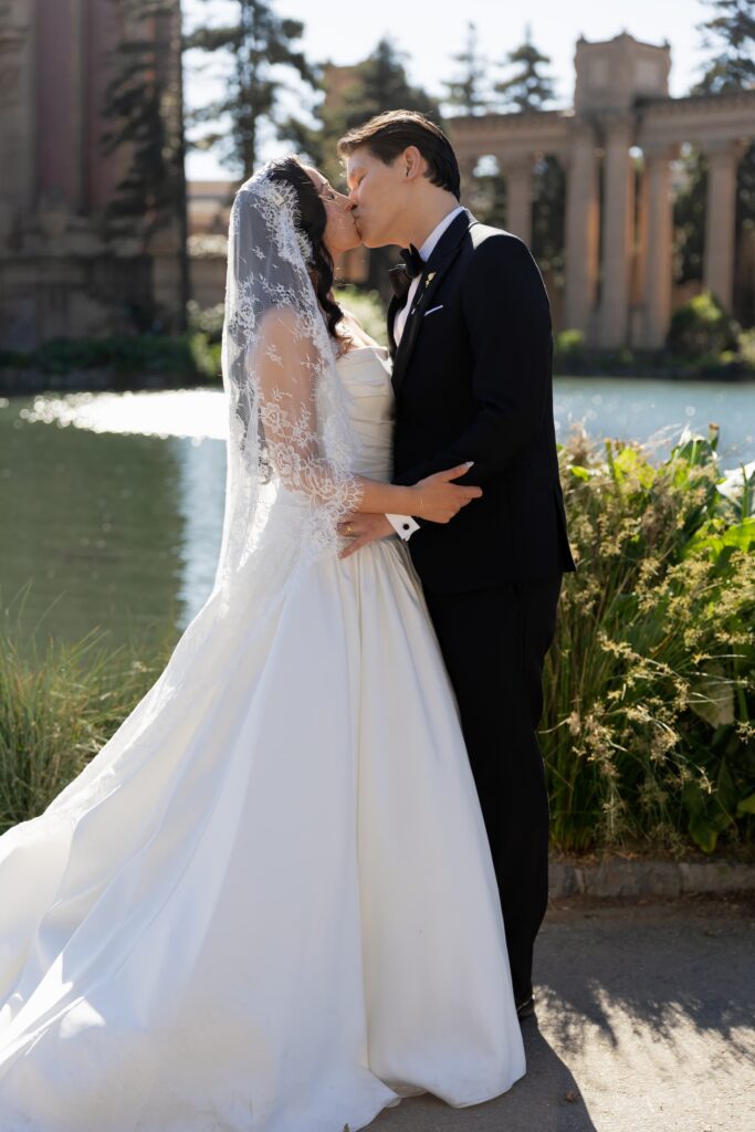 Bride and groom kissing at Palace of Fine Arts wedding, San Francisco wedding photographer Rose Freedman