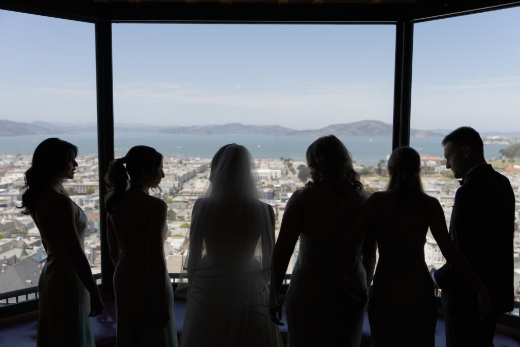 Bridesmaids silhouette at window with San Francisco Bay view during wedding getting ready, San Francisco wedding photographer Rose Freedman