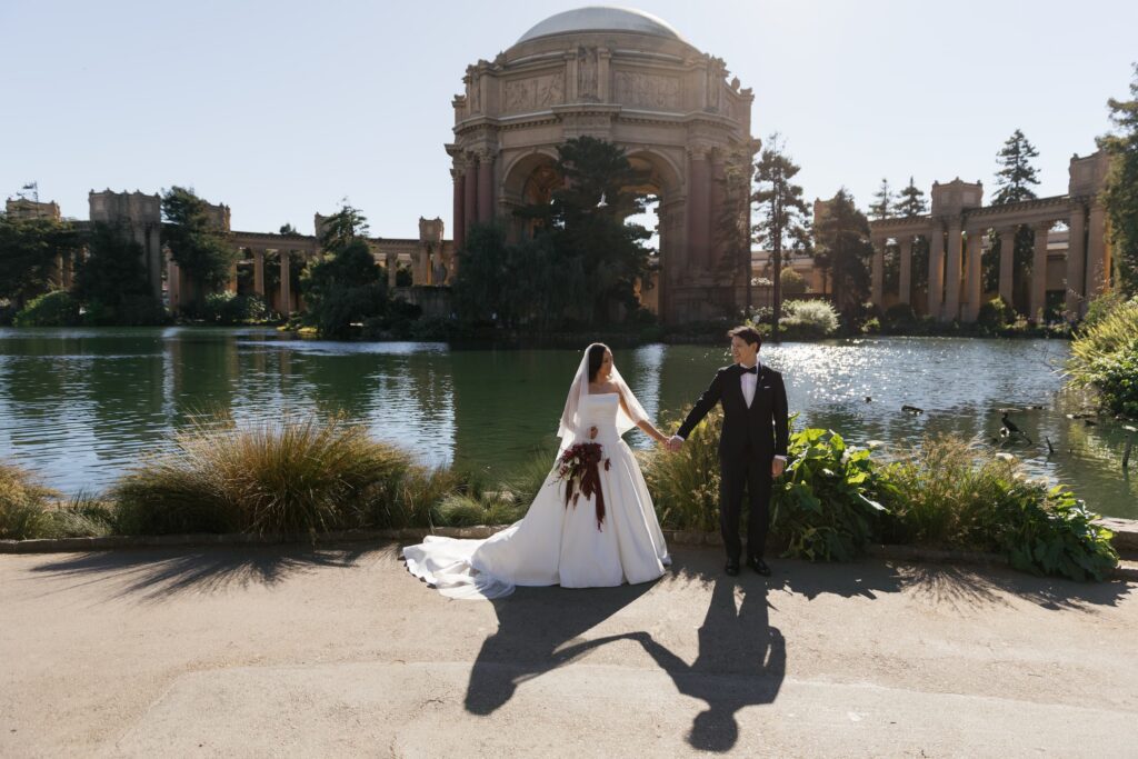 Bride and groom holding hands in front of Palace of Fine Arts rotunda San Francisco, San Francisco wedding photographer Rose Freedman
