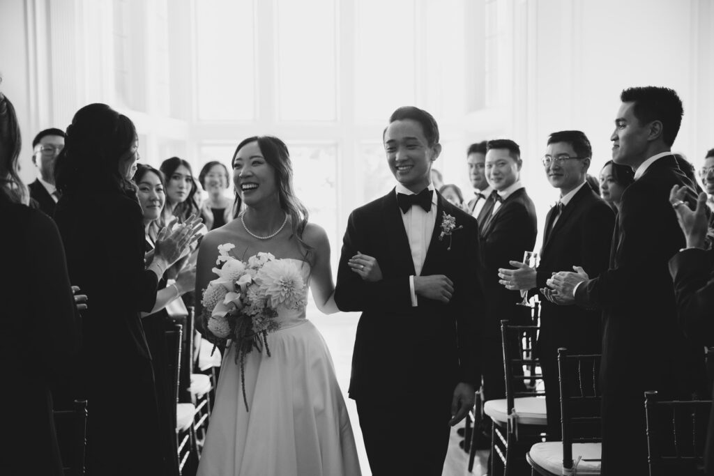 Bride and groom walking back up the aisle laughing at Kohl Mansion wedding, Bay Area wedding photographer Rose Freedman