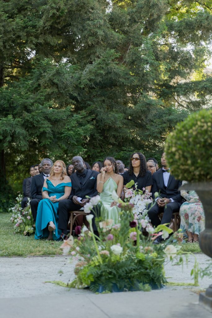 Wedding guests seated with lush aisle florals at Park Winters outdoor ceremony, Park Winters wedding photographer Rose Freedman