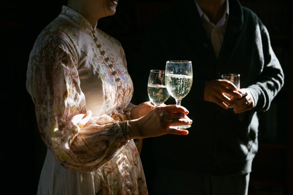 Wedding guests toasting with champagne at Kohl Mansion wedding, Bay Area wedding photographer Rose Freedman